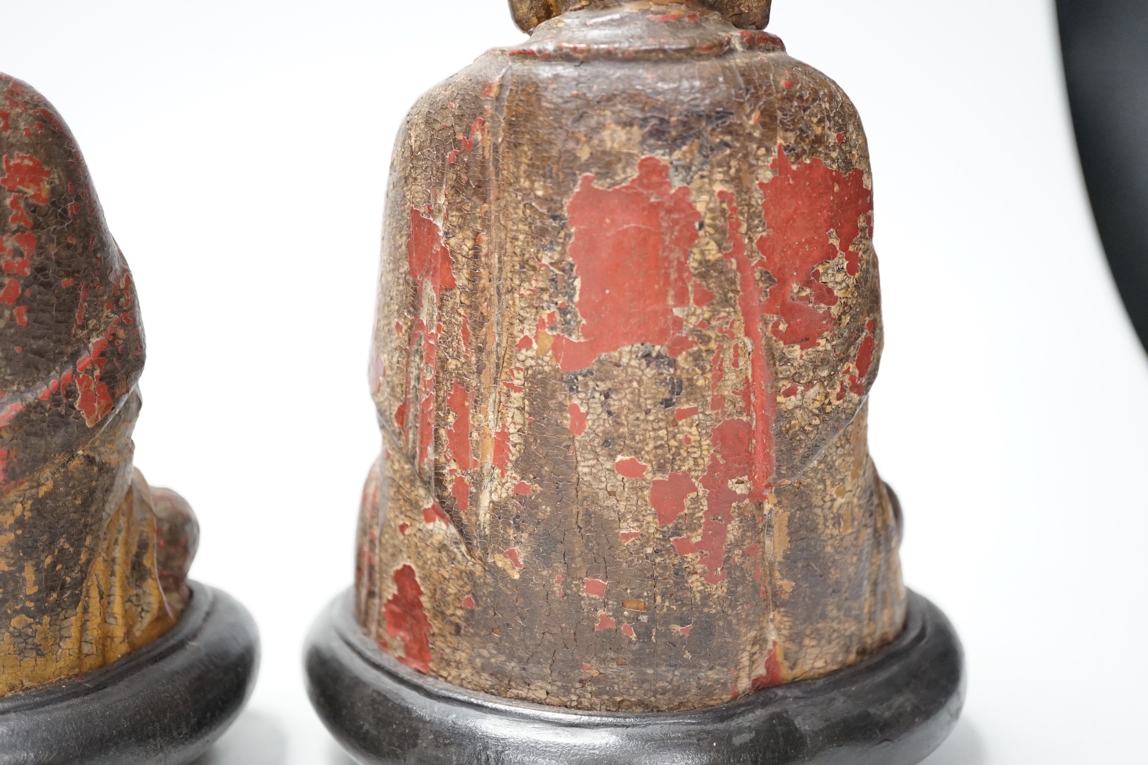 A set of three Chinese polychrome lacquered wood seated figures of Buddha, 19cm